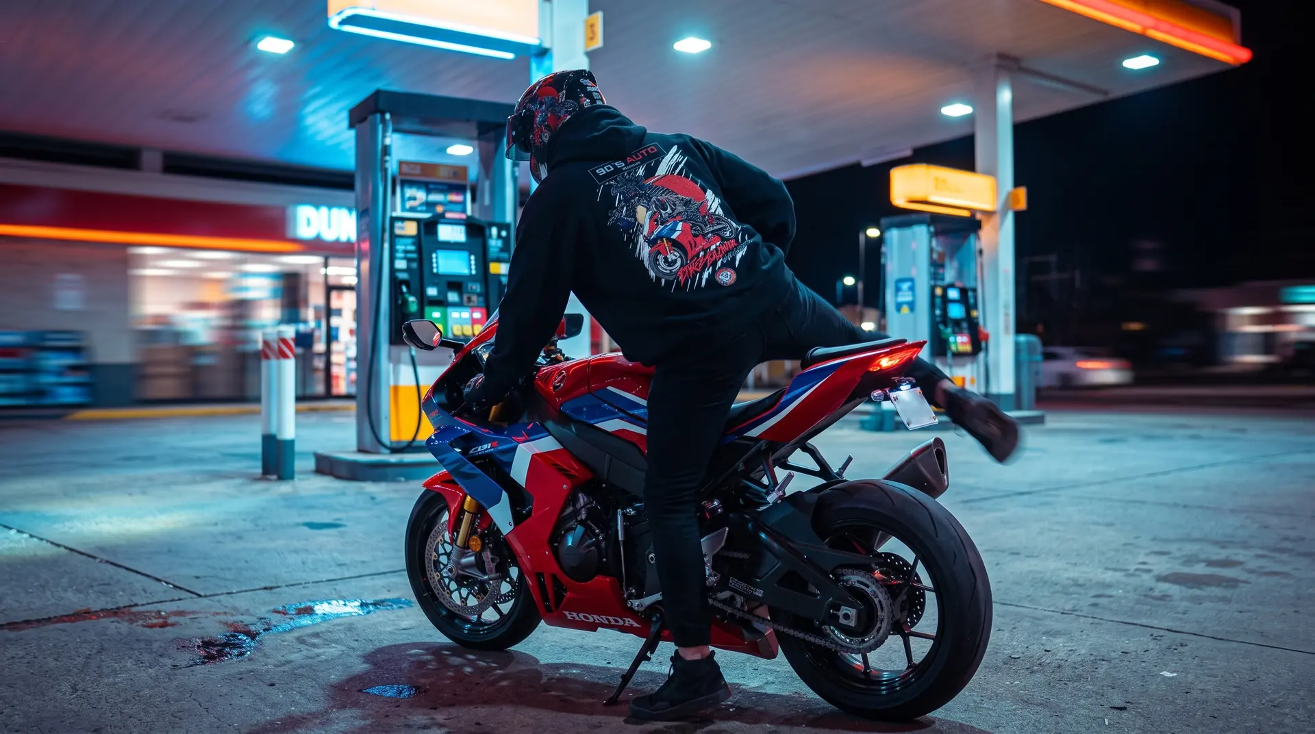 Rider in a 973 hoodie on a superbike at night